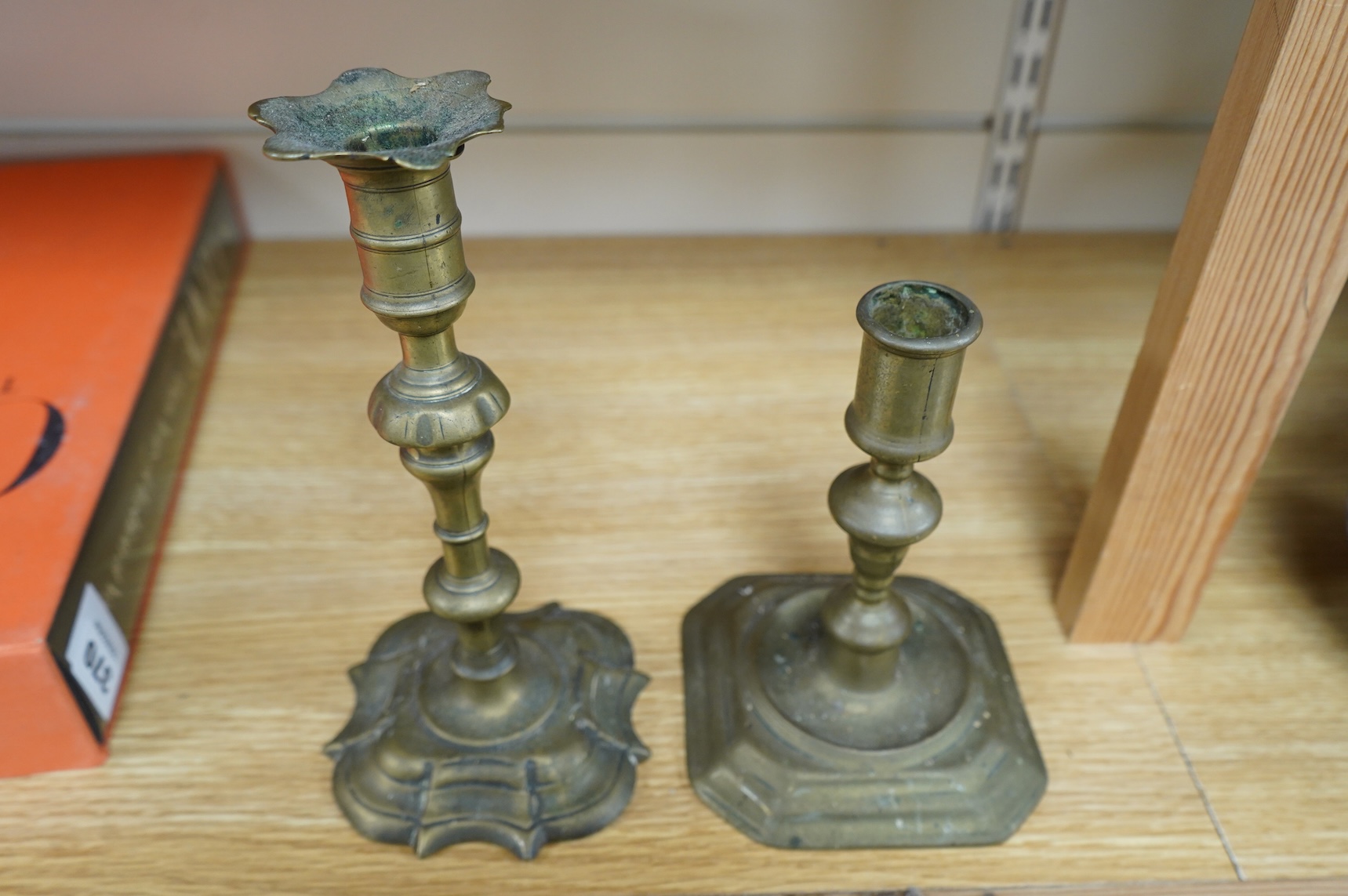 Two 18th century brass candlesticks, largest 23cm high